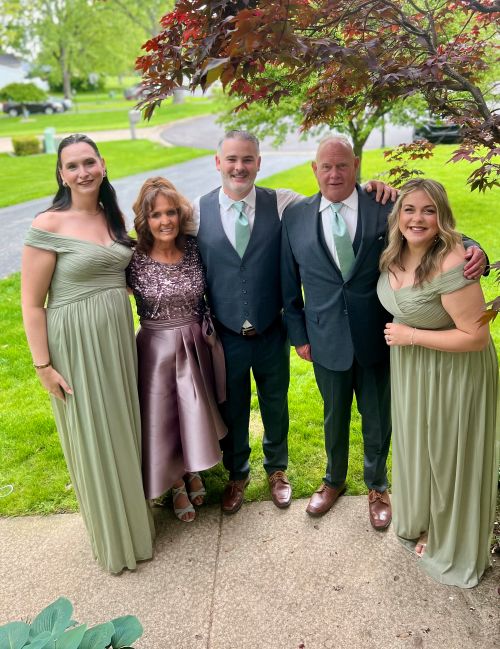 Camryn (left) with her family at her brother's wedding.